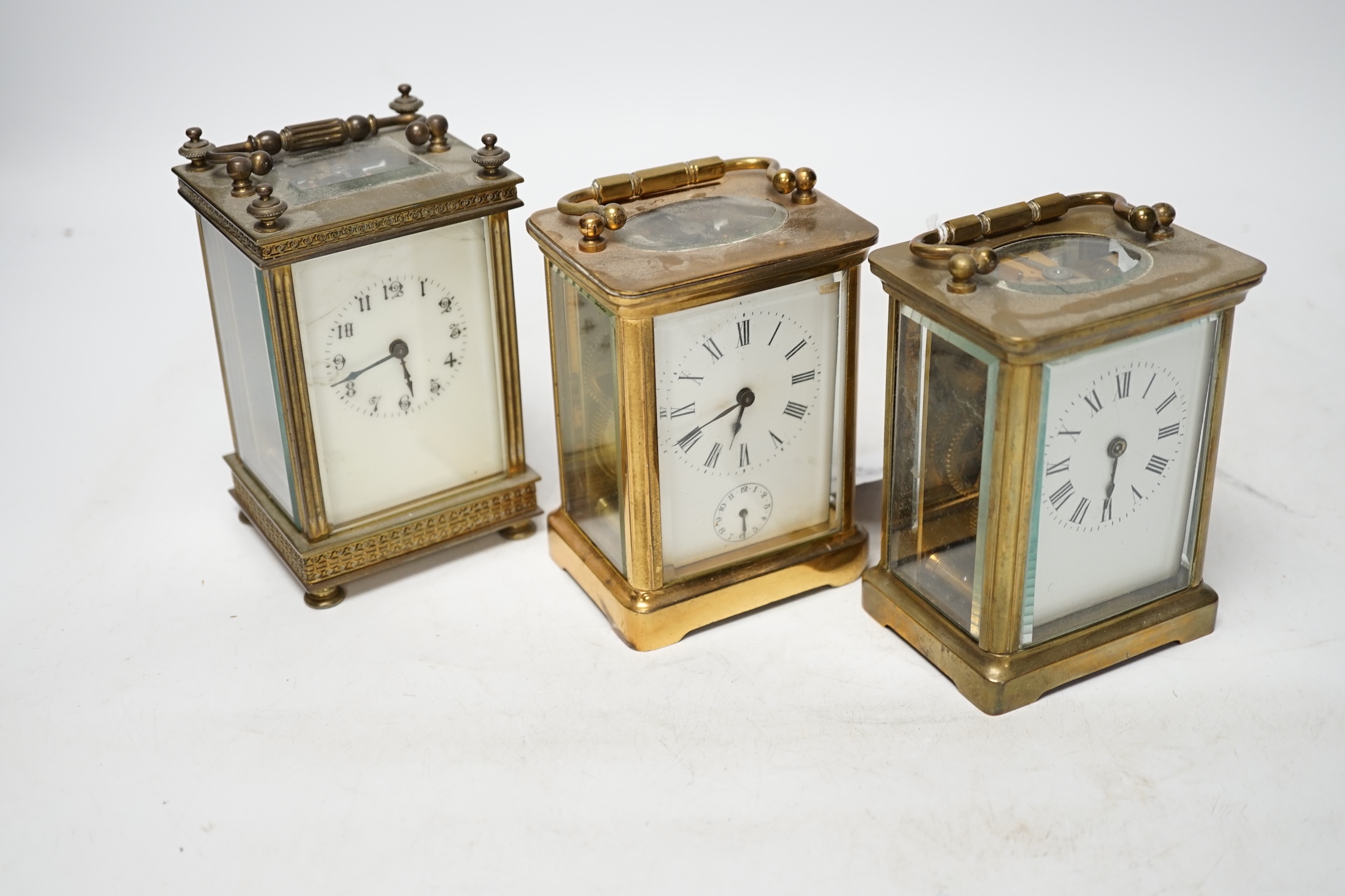 Three carriage timepieces with enamel dials, largest 14.5cm high. Condition - poor to fair